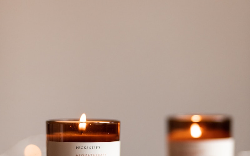 Finished handmade candles curing on a workshop table in rows